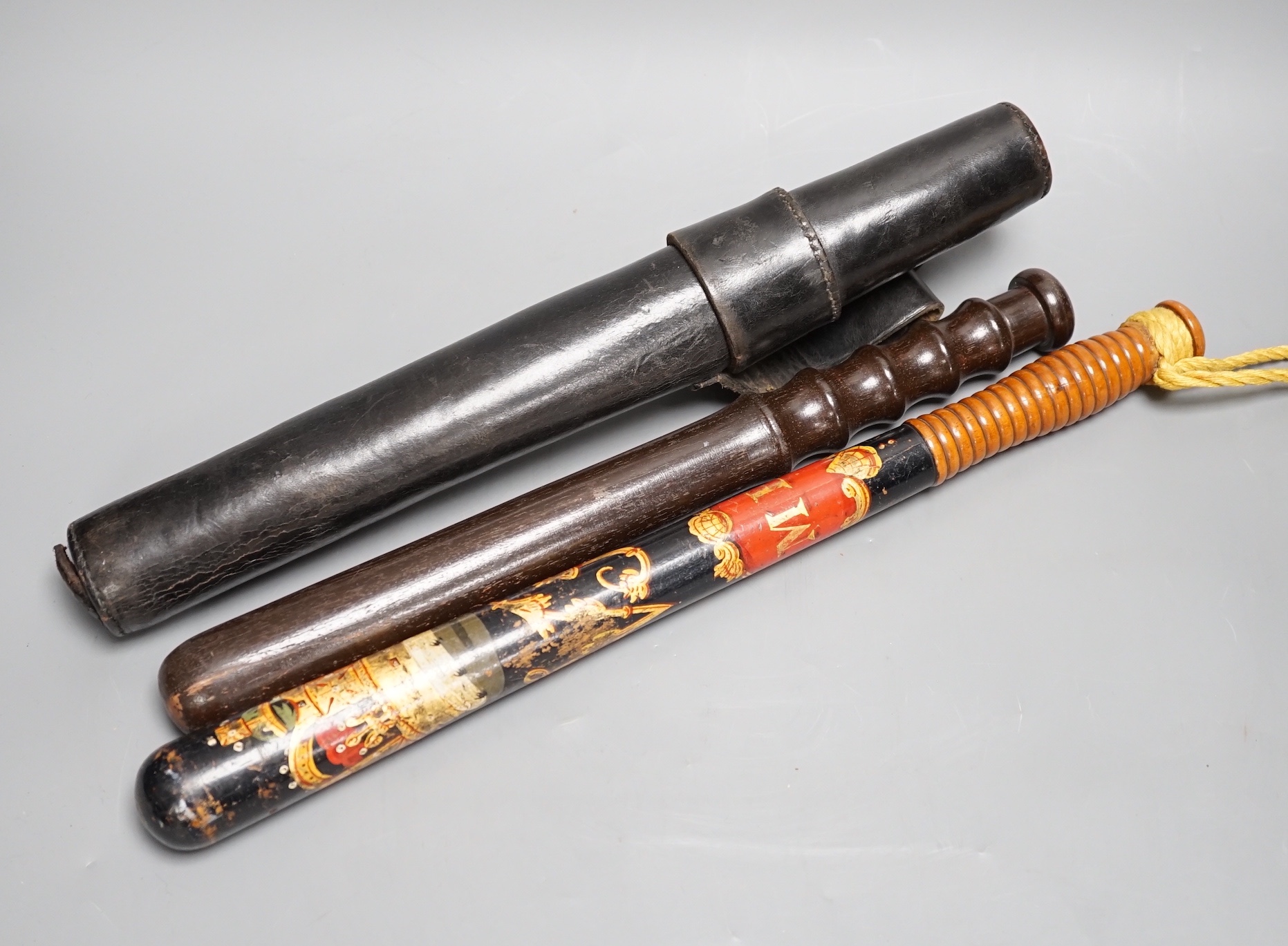 A Victorian painted wood ceremonial truncheon, 44cm and one other truncheon in leather case